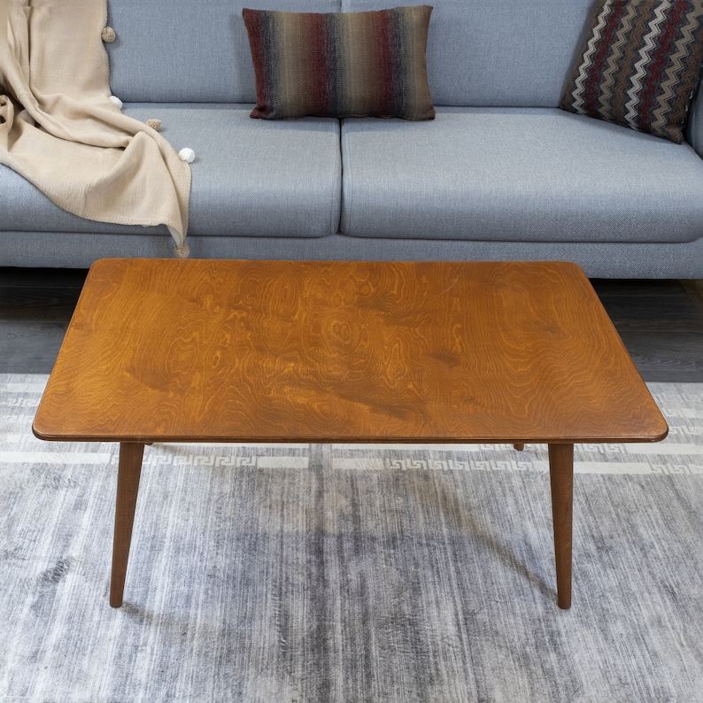 Discover the Modern Oval Coffee Table for your home! This versatile walnut coffee table, made from pine wood, fits seamlessly with any living room furniture.