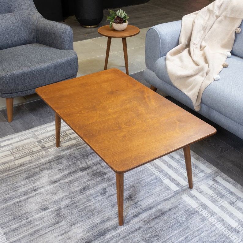 Discover the Modern Oval Coffee Table for your home! This versatile walnut coffee table, made from pine wood, fits seamlessly with any living room furniture.