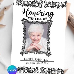 May include: A memorial card with the text "Honoring the Life of" above a framed photo of a woman. The card includes the name "Laura Johnson" and dates "April 4, 1950 - Jun 12, 2020". Decorative black floral borders frame the text and photo.