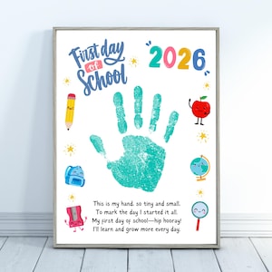 May include: A framed print with the words "First Day of School" and the year 2026. It features a teal handprint, a pencil, an apple, a backpack, a globe, a magnifying glass, and a pencil sharpener. The print includes a poem about the first day of school.