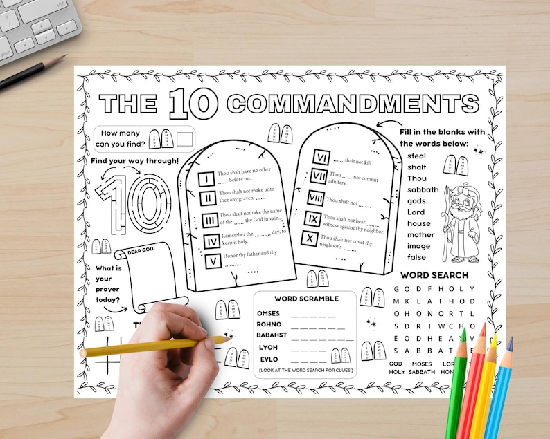 May include: Black and white coloring page with the text "THE 10 COMMANDMENTS". The page includes fill-in-the-blank sections, a word search, and a word scramble. A hand is holding a yellow pencil, ready to color.