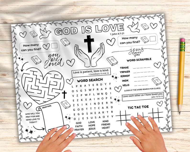 May include: A white activity sheet with the words "GOD IS LOVE" and various activities, including a maze, word search, and tic-tac-toe. The sheet also features the text "you are loved" and "Jesus loves you". A yellow pencil rests on the right side.