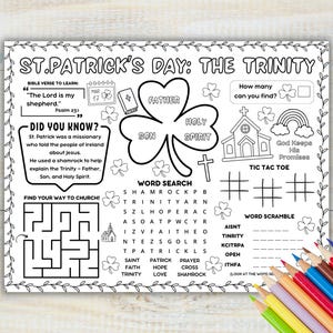 May include: A white ceramic mug with a black handle and the text "But First, Coffee" in a bold, black font. The mug is set against a blurred background, suggesting a cozy setting.