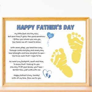 May include: A framed print with the text "HAPPY FATHER'S DAY" in blue. The print includes a poem, yellow footprints, and a blue heart with footprints. The frame is a light brown color.