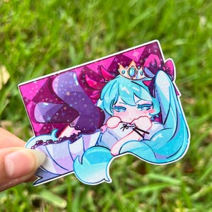 May include: A sticker featuring a cartoon character with long, light blue hair, a crown, and a bow. The character is lying down on a pink and purple background with a diamond pattern. The sticker has a white border.