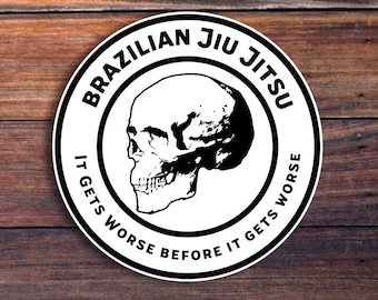 May include: Black and white sticker with a skull graphic and the text "Brazilian Jiu Jitsu It Gets Worse Before It Gets Worse".