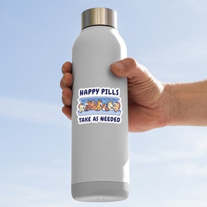 May include: A gray stainless steel water bottle with a sticker that says "Happy Pills Take as Needed". The sticker features a cartoon illustration of a pill bottle with happy cartoon animals inside.