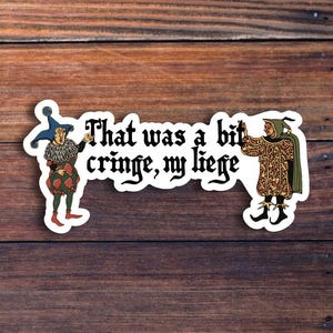 May include: A sticker with the text "That was a bit cringe, my liege" in a gothic font. The sticker features two medieval jesters on either side of the text, set against a wooden background.