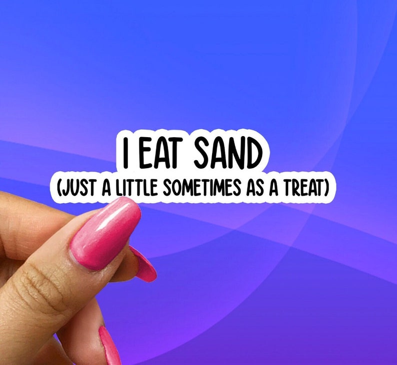 May include: A pink fingernail with a white sticker that reads "I EAT SAND (JUST A LITTLE SOMETIMES AS A TREAT)"