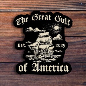 May include: Black and white sticker with the text "The Great Gulf of America" in a stylized font. The sticker features a ship sailing on the water with a sun and clouds in the background. The text "Est. 2025" is also included.