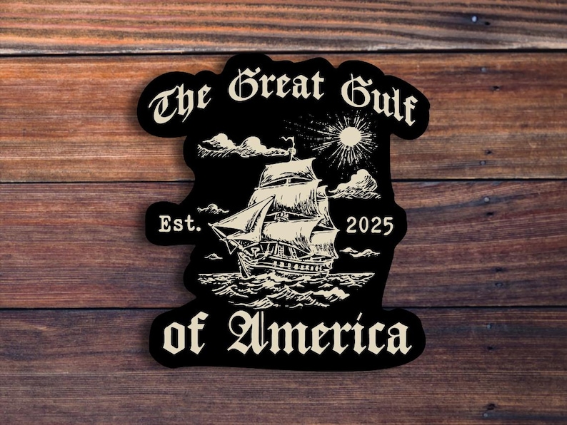 May include: Black and white sticker with the text "The Great Gulf of America" in a stylized font. The sticker features a ship sailing on the water with a sun and clouds in the background. The text "Est. 2025" is also included.