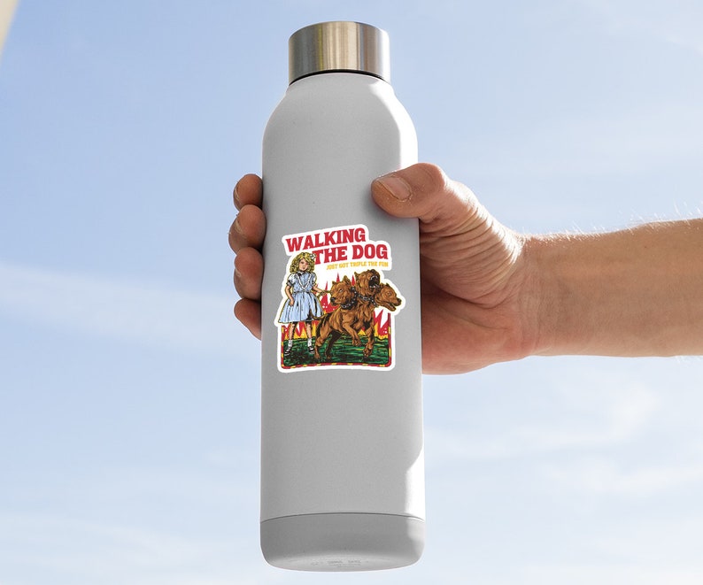 May include: A white water bottle with a sticker of a girl walking a three-headed dog. The sticker says "Walking the Dog, Don't Get Snapped by the Pup."