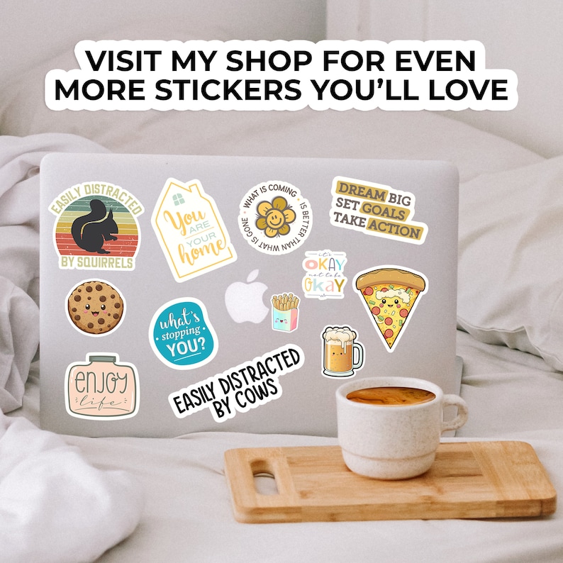 May include: A laptop computer with various stickers on it. The stickers feature cute illustrations and motivational quotes. Some of the stickers include: "Easily Distracted by Squirrels", "You are your home", "What is coming is better than what is gone", "Dream Big Set Goals Take Action", "Okay Okay Okay", "What's stopping you?", "Easily Distracted by Cows", "Enjoy Life".
