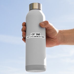 May include: A gray stainless steel water bottle with a white sticker that says "I eat sand, just a little sometimes as a treat".