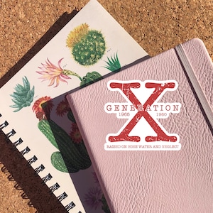 May include: A pink notebook with a white sticker that says "Generation X 1965-1980 Raised on hose water and neglect". The sticker features a red "X" with a distressed look.