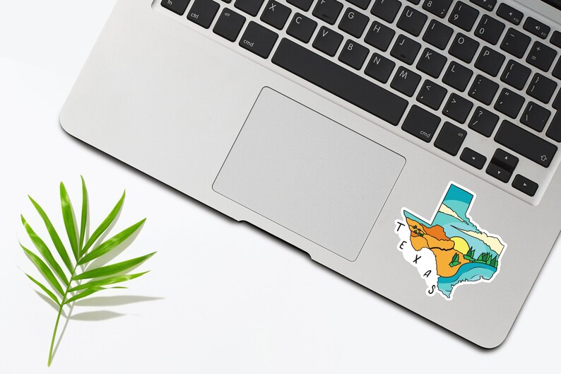 May include: A sticker of the state of Texas with a colorful landscape design. The sticker is on a silver laptop.