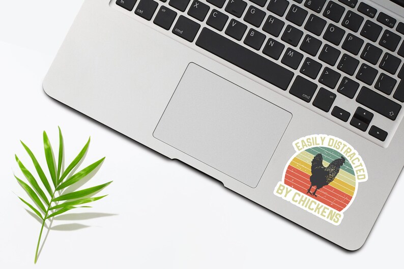 May include: A sticker with a retro design featuring a chicken and the text "Easily Distracted by Chickens".