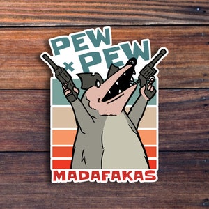 May include: A cartoon illustration of a gray animal with a black hat holding two guns, with the text "PEW PEW MADAFAKAS" in a retro style.