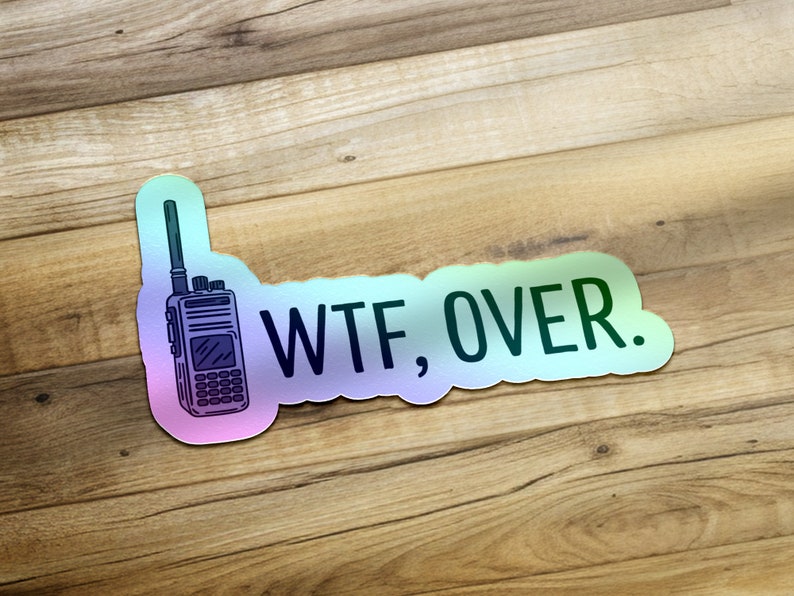 May include: A sticker with a rainbow gradient background featuring a black and white illustration of a walkie-talkie and the text "WTF, OVER."