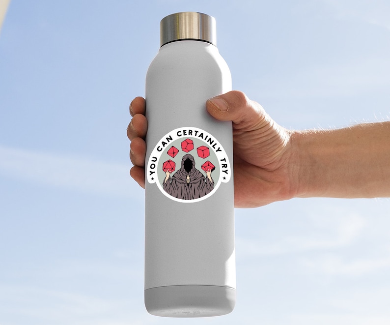 May include: A white water bottle with a round sticker featuring a hooded figure holding red dice. The sticker says "You can certainly try."
