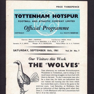 May include: A black and white program for a Tottenham Hotspur football match against Wolverhampton Wanderers on September 16th, 1961. The program features a black and white illustration of a wolf and a soccer ball.