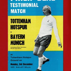 May include: Vintage souvenir program for Philip Beal's testimonial match. The program features a player in a white jersey and black shorts, with text in white and black on a blue and yellow background. The match was between Tottenham Hotspur and Bayern Munich.