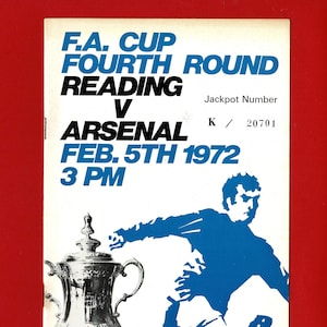 May include: A vintage football programme cover for the F.A. Cup Fourth Round match between Reading and Arsenal, played on February 5th, 1972. The design includes a blue player illustration and a silver trophy.