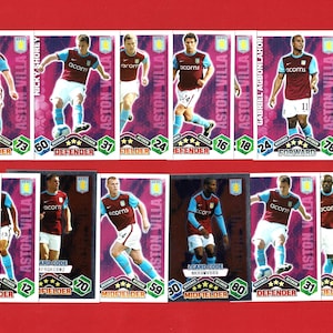 May include: A collection of Aston Villa football trading cards. Each card features a player in the team's colors, with their name, position, and rating displayed. The cards are set against a red background.