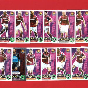 May include: A collection of West Ham United football trading cards. Each card features a player or the manager, with the team's logo and player information. The cards are set against a purple and white background.
