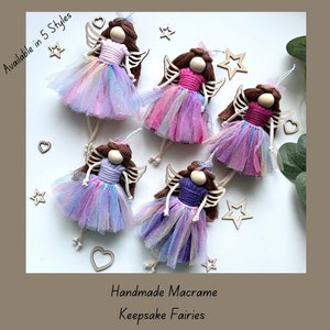 May include: Five handmade macrame fairy ornaments with iridescent tulle skirts and wooden wings. The fairies are available in five different colours: pink, purple, blue, white, and green.  Available in 5 Styles.