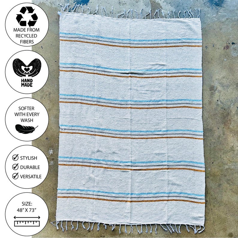 Beach blanket made from upcycled cotton, perfect for beach days, picnics, or yoga. This colorful Mexican blanket is a versatile outdoor blanket, ideal for summer adventures, camping, or as a cozy home decor throw. Soft, lightweight, and eco-friendly, it doubles as a boho throw blanket, blanket gift, or decorative layer for any coastal space. Handwoven by artisans, this sustainable, upcycled cotton blanket adds comfort and style wherever it goes.