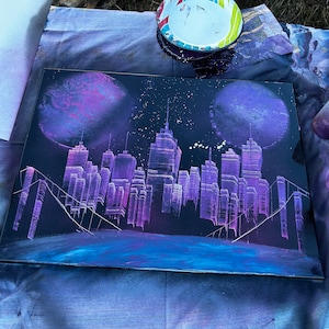 Spray paint city skyline on canvas