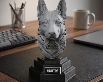 May include: A gray German Shepherd head sculpture on a black tiered base. The base has a white rectangle with the text "YOUR TEXT". The sculpture is on a black desk mat, with a keyboard, pens, and a mug in the background.