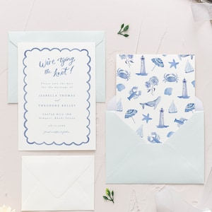 May include: A save the date card with a blue and white watercolor design featuring a lighthouse, seashells, and a whale. The text on the card reads "We're tying the knot!" and includes the names Isabella Thomas and Theodore Kelley, the date 08.13.2023, and the location Castle Hill Inn, Newport, Rhode Island.