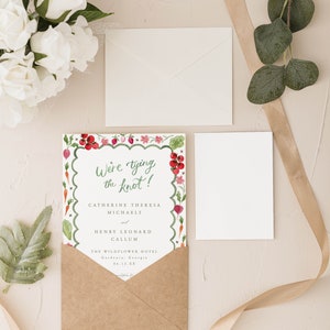 May include: A wedding invitation with a watercolor illustration of vegetables and flowers. The text reads "We're tying the knot!" Catherine Theresa Michaels and Henry Leonard Callum. The Wildflower Hotel, Gardenia, Georgia, 06.12.XX.