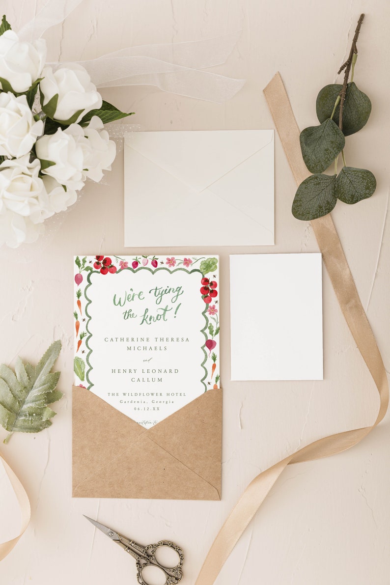 May include: A wedding invitation with a watercolor illustration of vegetables and flowers. The text reads "We're tying the knot!" Catherine Theresa Michaels and Henry Leonard Callum. The Wildflower Hotel, Gardenia, Georgia, 06.12.XX.