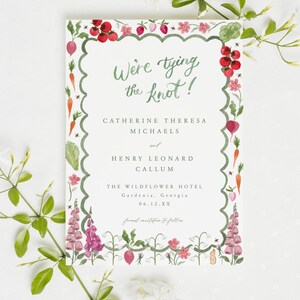May include: A save-the-date card with a watercolor illustration of a garden border. The text reads "We're tying the knot!" Catherine Theresa Michaels and Henry Leonard Callum. The Wildflower Hotel, Gardenia, Georgia. 06.12.XX. Formal invitation to follow.