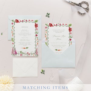May include: A light blue envelope with a white invitation card inside. The invitation card features a watercolor illustration of a garden with carrots, flowers, and other plants. The text on the card reads "Please join us for a bridal shower honoring Frances Rose Thames".