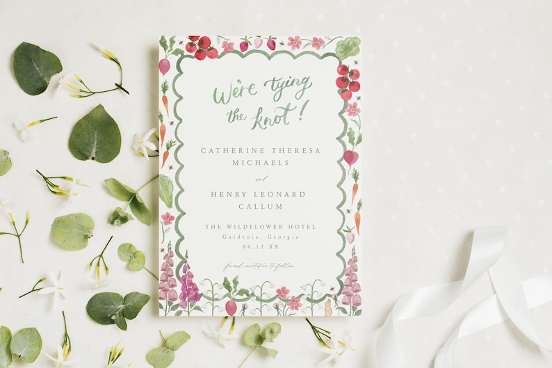 May include: A wedding invitation with a green border featuring a watercolor illustration of vegetables and flowers. The text reads "We're tying the knot!" followed by the names Catherine Theresa Michaels and Henry Leonard Callum, the date 8.12.XX, and the location The Wildflower Hotel, Gardenia, Georgia.
