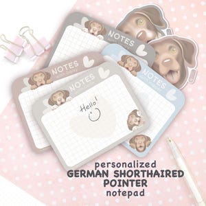 May include: A stack of personalized German Shorthaired Pointer notepads in various pastel colors. Each notepad features a cartoon dog illustration and the text "NOTES" with a name. One notepad has "Hello!" written on it.