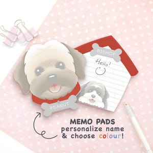 May include: A dog-shaped memo pad with a grey and white puppy illustration wearing a red collar with a bone-shaped tag labelled PEANUT, next to a house-shaped memo pad with a bone-shaped header labelled BISHOP and a small puppy illustration.