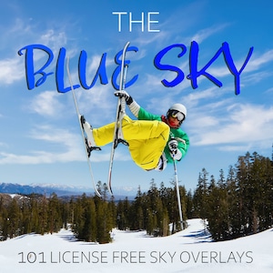 May include: A skier performs a trick in the air against a blue sky with white clouds. The text "THE BLUE SKY" is written in blue letters across the top of the image. The text "101 LICENSE FREE SKY OVERLAYS" is written in black letters at the bottom of the image.