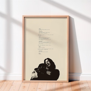 Puede incluir: Una impresión enmarcada con una imagen en blanco y negro de una persona abrazando a otra, sobre un fondo beige. La parte superior de la impresión muestra texto en una fuente serif. El marco es de color madera clara.