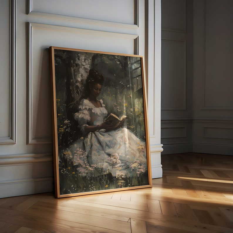 May include: A framed painting of a person sitting in a forest clearing, reading a book. The person is wearing a white dress and has dark skin. The background is a lush green forest with a birch tree.
