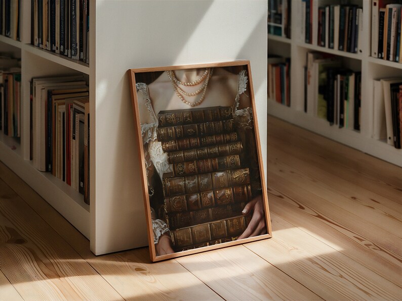 May include: A framed print of a woman wearing a white dress and a pearl necklace, holding a stack of antique books in front of her chest.