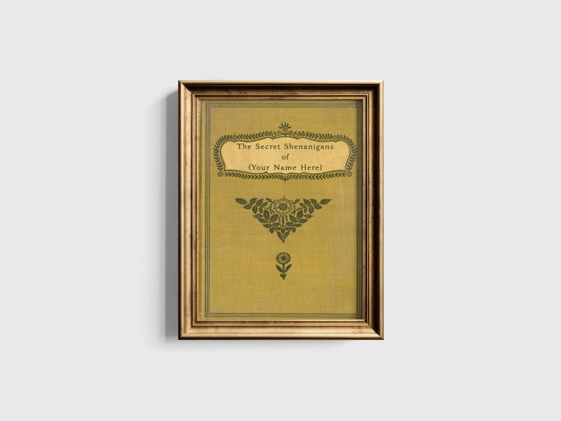 May include: A gold framed print with a yellow background and green floral design. The text reads "The Secret Shenanigans of (Your Name Here)"