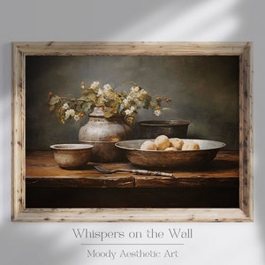 May include: A still life painting depicting a wooden table with a bowl of potatoes, a vase of white flowers, and two metal bowls. The painting is framed in a rustic wooden frame. The title "Whispers on the Wall" is written below the painting.
