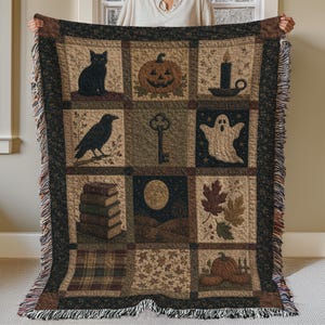 May include: A rectangular woven throw blanket featuring a grid of nine panels with Halloween-themed imagery including a black cat, jack-o'-lantern, candle, raven, skeleton key, ghost, stack of books, full moon, autumn leaves, and pumpkins with fringed edges.