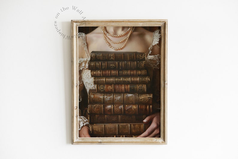 May include: A framed print depicting a woman holding a stack of antique books in front of her chest. The books are bound in brown leather with gold accents and feature intricate designs on the covers. The woman is wearing a white lace dress and a pearl necklace.