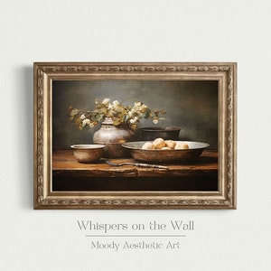 May include: A still life painting depicting a rustic wooden table with a silver vase filled with white flowers, a bowl of fruit, and other silver bowls. The painting is framed in a gold frame and has the text "Whispers on the Wall" and "Moody Aesthetic Art" below the image.